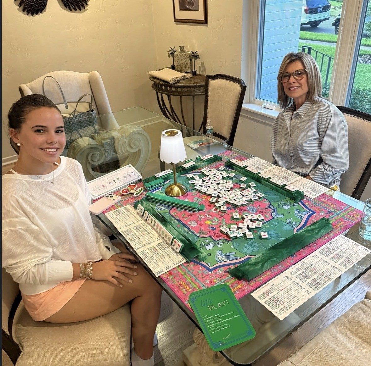 Two players enjoying a relaxed game of mahjong at home